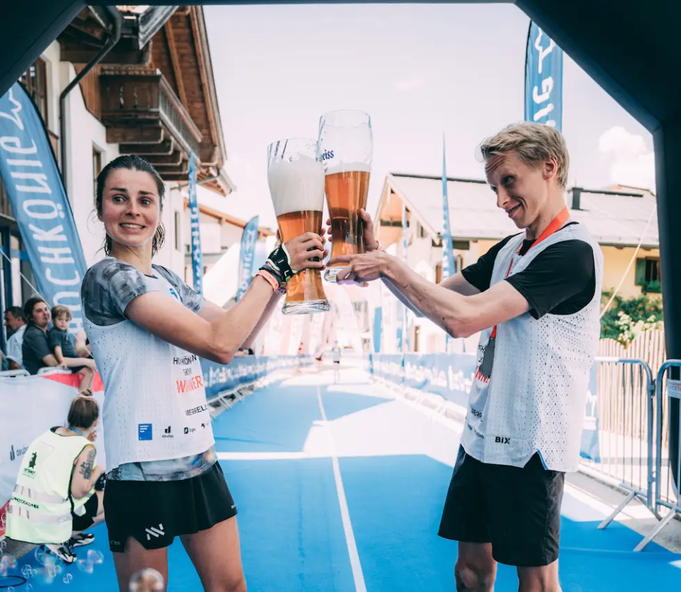 Male and Female Athletes holding giant beer glasses