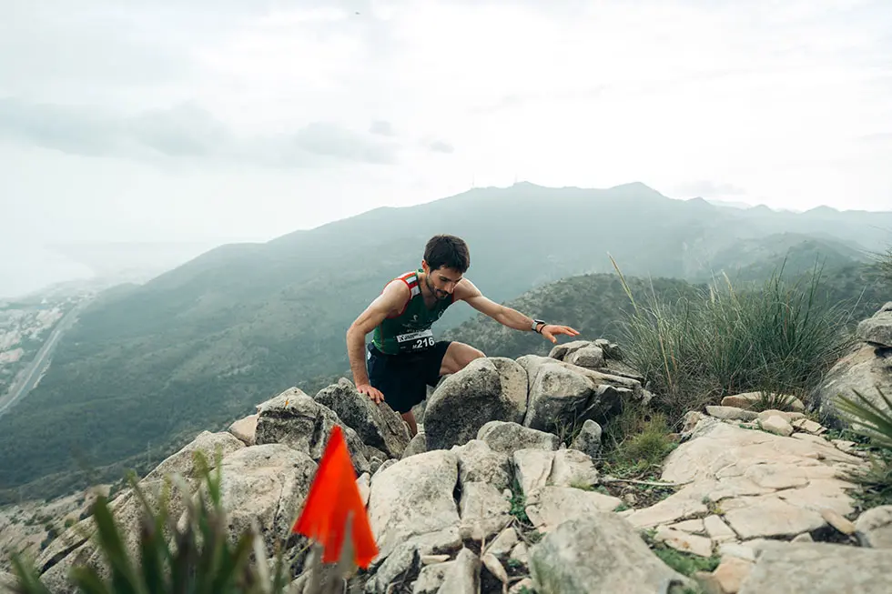Mountain runners crossing steep and technical terrain during an alpine race