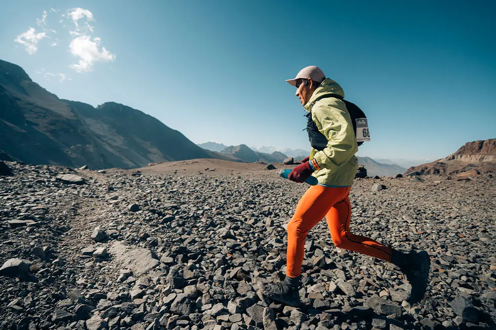Beginner mountain runner following a marked trail during a first mountain race